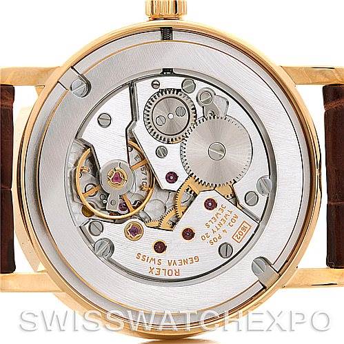 The image shows a back view of the Rolex Cellini 5115 Men's Yellow Gold Silver Dial 5115 Men's Yellow Gold Silver Dial watch, highlighting its intricate mechanical movement and internal components.