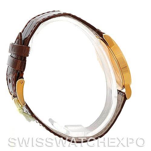 This Rolex Cellini 5115 Men's Yellow Gold Silver Dial 5115 Men's Yellow Gold Silver Dial watch is shown from a side angle, displaying its brown leather strap and gold-tone case and buckle.