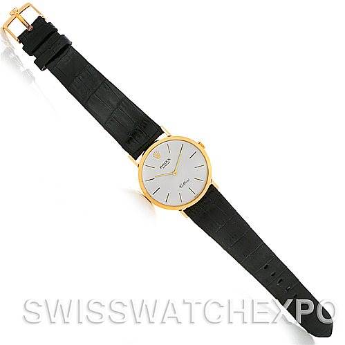 The image shows a top view of a Rolex Cellini 4112 Men's Yellow Gold Silver Dial 4112 Men's Yellow Gold Silver Dial watch with a gold case and a black leather strap.