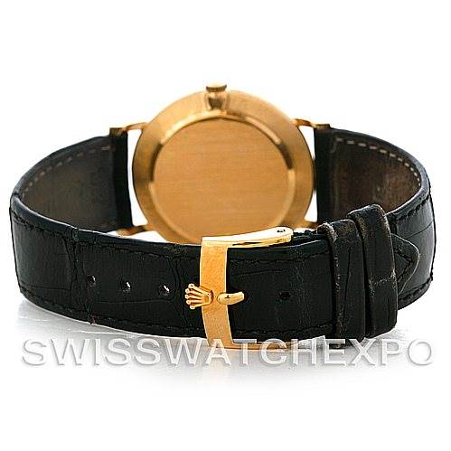 The image shows the back of a Rolex Cellini 5112 Men's Yellow Gold Beige Dial 5112 Men's Yellow Gold Beige Dial watch, highlighting its gold clasp and black leather strap.