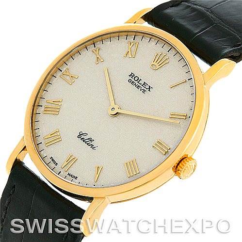 The image shows a side angle of a Rolex Cellini 5112 Men's Yellow Gold Beige Dial 5112 Men's Yellow Gold Beige Dial watch featuring a gold case, white dial with Roman numerals, and a black leather strap.