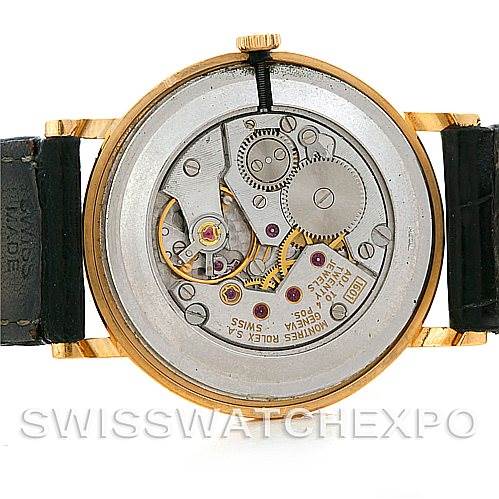 This image shows the open case back of a Rolex Cellini 5112 Men's Yellow Gold Beige Dial 5112 Men's Yellow Gold Beige Dial watch, revealing its intricate mechanical movement.