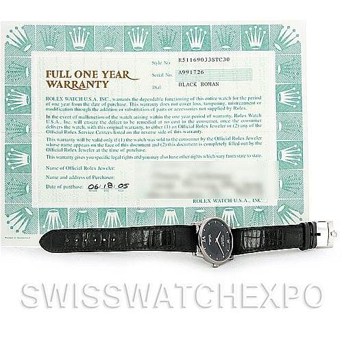 This image shows a Rolex Cellini 5116 Men's White Gold Black Dial 5116 Men's White Gold Black Dial watch laid flat, displaying the watch face, black strap, and clasp, accompanied by its warranty card.