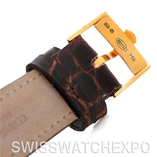 This image shows a close-up of the leather strap and gold buckle of a Rolex Cellini 5115 Men's Yellow Gold Silver Dial 5115 Men's Yellow Gold Silver Dial watch.