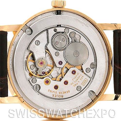 This image shows the Rolex Cellini 5115 Men's Yellow Gold Silver Dial 5115 Men's Yellow Gold Silver Dial watch from the back, highlighting its internal mechanisms and movement components.