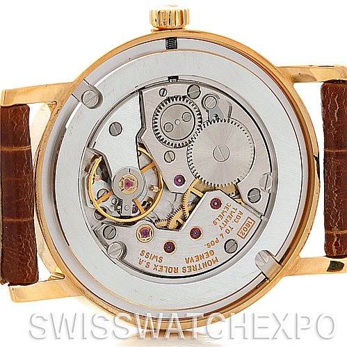 The image shows the back of the Rolex Cellini 5115 Men's Yellow Gold Grey Dial 5115 Men's Yellow Gold Grey Dial watch, highlighting its intricate internal movement mechanism.