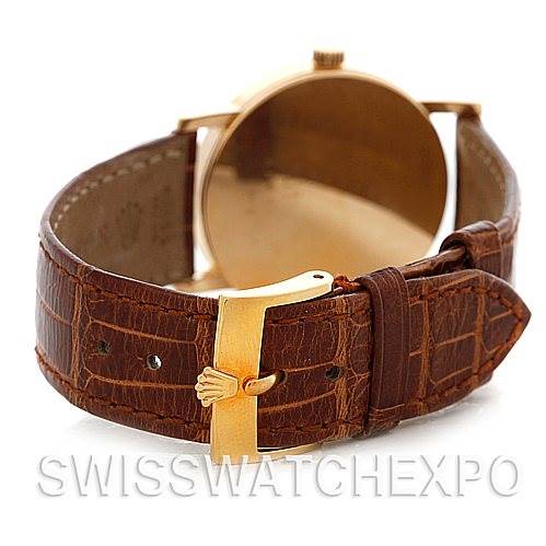 The image shows the back of a Rolex Cellini 5115 Men's Yellow Gold Grey Dial 5115 Men's Yellow Gold Grey Dial watch with a brown leather strap and a gold buckle.