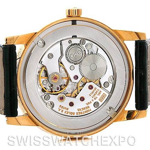 The image shows the back view of a Rolex Cellini 5116 Men's Yellow Gold Black Dial 5116 Men's Yellow Gold Black Dial watch, highlighting its intricate mechanical movement and components.