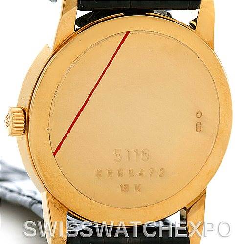 This image shows the back case of a Rolex Cellini 5116 Men's Yellow Gold Black Dial 5116 Men's Yellow Gold Black Dial model watch, highlighting its serial number and gold 18K marking.