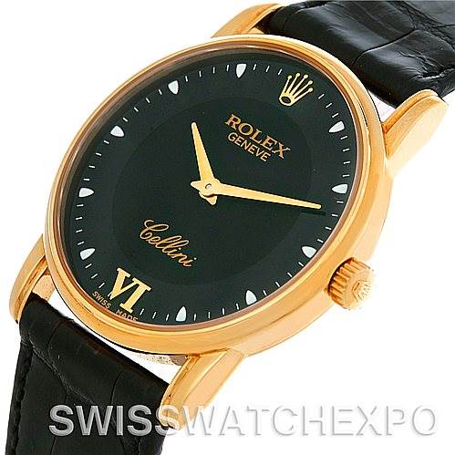 This image shows a Rolex Cellini 5116 Men's Yellow Gold Black Dial 5116 Men's Yellow Gold Black Dial watch from an angle that highlights the face, crown, and part of the leather strap.