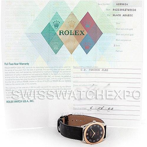 The image shows a Rolex Cellini 4233 Men
s White Gold Black Dial 4233 Men
s White Gold Black Dial watch laid flat, along with its warranty card and documents set behind it.