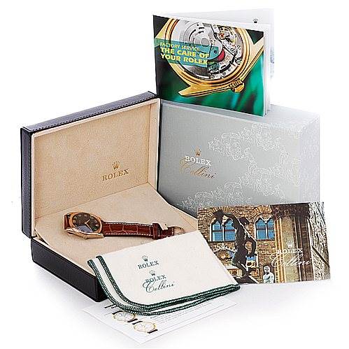 This image shows a Rolex Cellini 4233 Men's White Gold Black Dial 4233 Men's White Gold Black Dial watch, its box, cleaning cloth, booklets, and additional accessories from a slightly elevated angle.