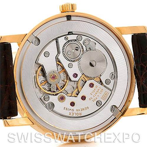 The image shows the back view of the Rolex Cellini 5115 Men's Yellow Gold Beige Dial 5115 Men's Yellow Gold Beige Dial watch, showcasing its internal mechanical movements and components.