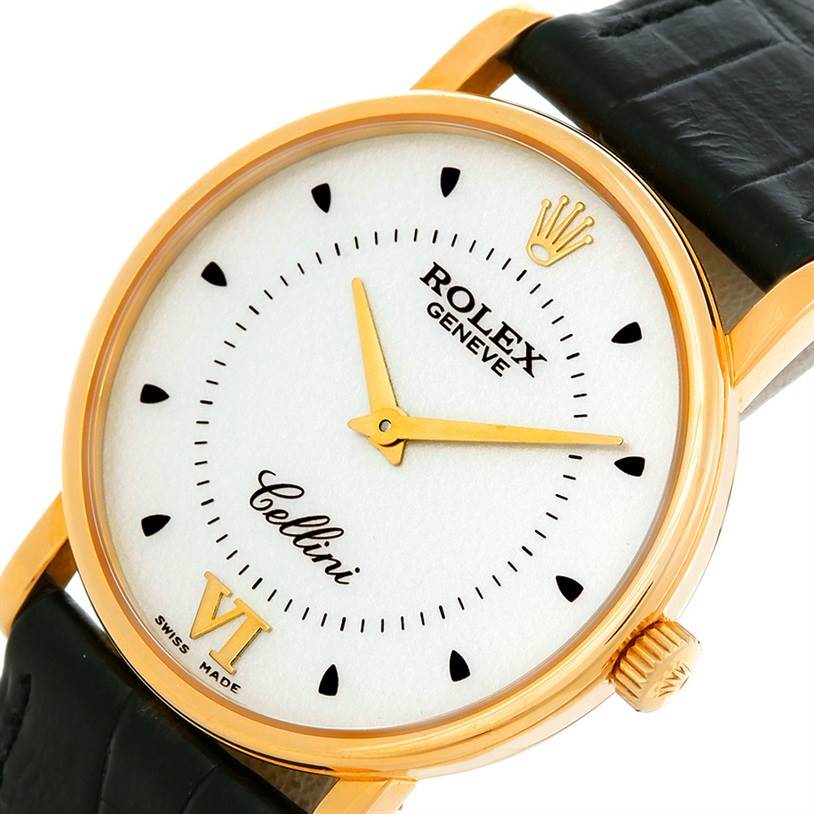 This image shows a close-up of the Rolex Cellini 5115 Men's Yellow Gold Silver Dial 5115 Men's Yellow Gold Silver Dial model watch, highlighting the dial, golden case, crown, and a portion of the strap.