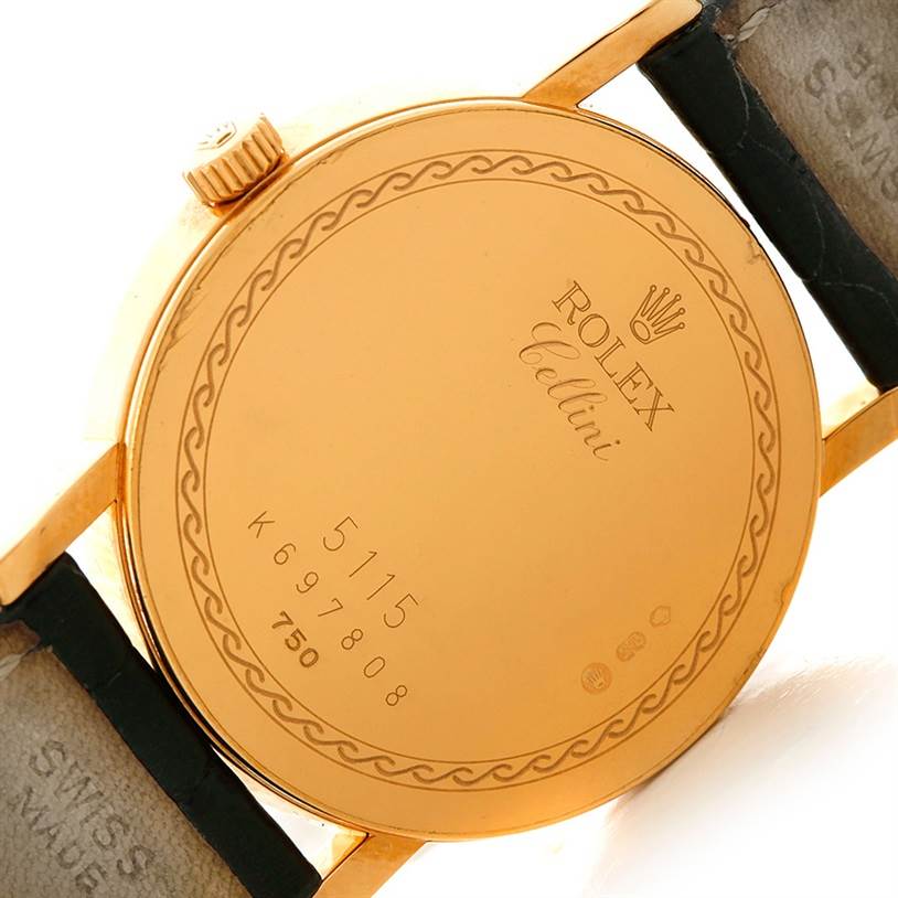 This image shows the back of a Rolex Cellini 5115 Men's Yellow Gold Silver Dial 5115 Men's Yellow Gold Silver Dial watch, featuring the case back, serial number, crown, and part of the watch strap.