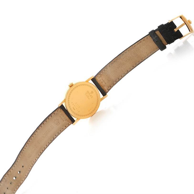 The image shows the back view of a Rolex Cellini 5115 Men's Yellow Gold Silver Dial 5115 Men's Yellow Gold Silver Dial watch, displaying the leather strap and the watch case.