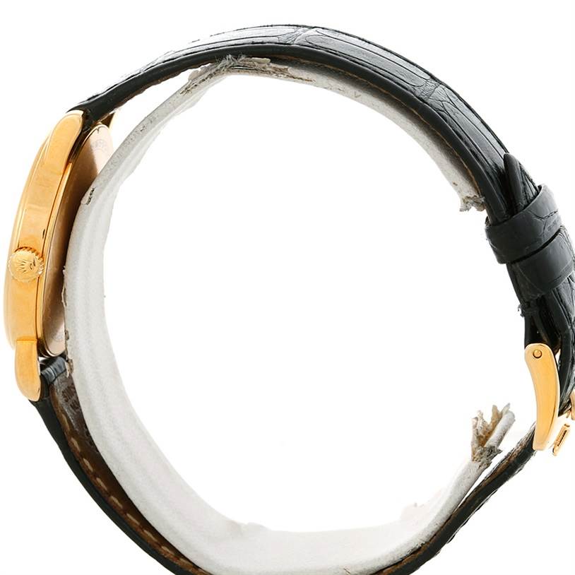 This image shows a side view of a Rolex Cellini 5115 Men's Yellow Gold Silver Dial 5115 Men's Yellow Gold Silver Dial watch, highlighting the case, crown, and leather strap.