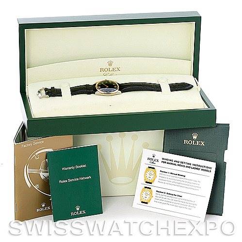 The image shows a Rolex Cellini 4233 Men's White Gold Black Dial 4233 Men's White Gold Black Dial watch in its original packaging, along with warranty and instruction booklets, and a factory service booklet.