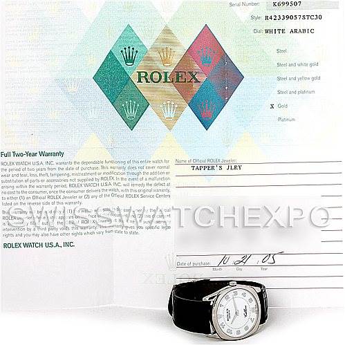 The image shows a Rolex Cellini 4233 Men's White Gold White Dial 4233 Men's White Gold White Dial watch lying flat along with its warranty card and documentation.