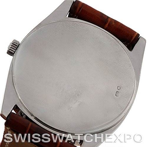 This image shows the back case and crown of a Rolex Cellini 4233 Men's White Gold Black Dial 4233 Men's White Gold Black Dial watch with a brown leather strap.