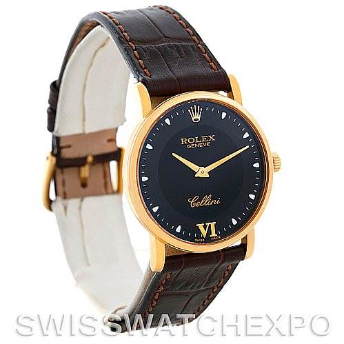 The Rolex Cellini 5115 Men's Yellow Gold Black Dial 5115 Men's Yellow Gold Black Dial watch is shown from a three-quarter angle, displaying its black dial, gold case, and brown leather strap.