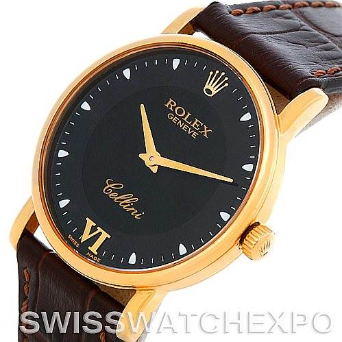 This image shows a close-up angled view of the Rolex Cellini 5115 Men's Yellow Gold Black Dial 5115 Men's Yellow Gold Black Dial watch, featuring its black dial, gold case, crown, and leather strap.