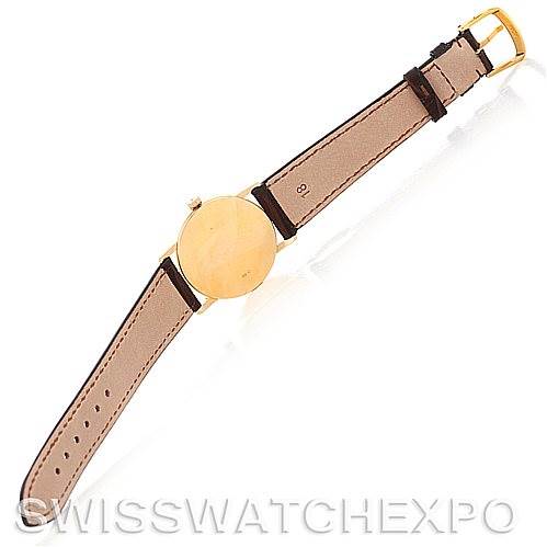 This Rolex Cellini 5115 Men's Yellow Gold Black Dial 5115 Men's Yellow Gold Black Dial watch is shown from the back, displaying its leather strap, gold case, and buckle.