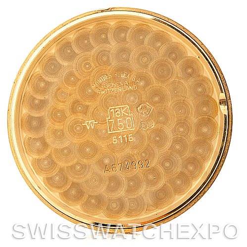 This image shows the inner back case of a Rolex Cellini 5115 Men's Yellow Gold Black Dial 5115 Men's Yellow Gold Black Dial watch, featuring hallmarks and a decorative pattern.