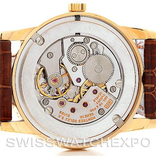 This image shows the back of a Rolex Cellini 5116 Men
s Yellow Gold Beige Dial 5116 Men
s Yellow Gold Beige Dial model watch, highlighting its movement and internal mechanisms.