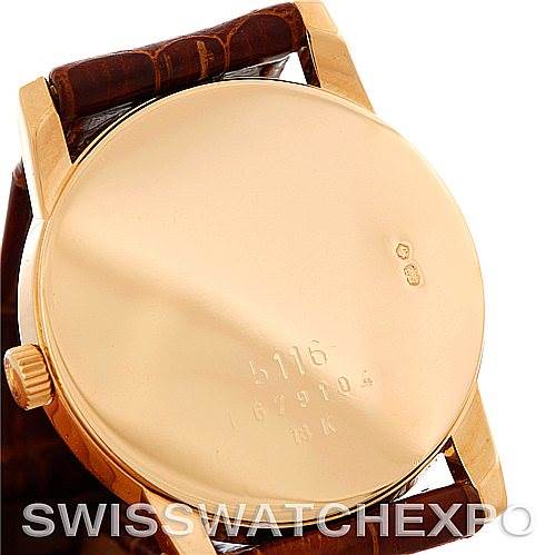 The image shows the back case and crown of a Rolex Cellini 5116 Men
s Yellow Gold Beige Dial 5116 Men
s Yellow Gold Beige Dial watch from an angled perspective.