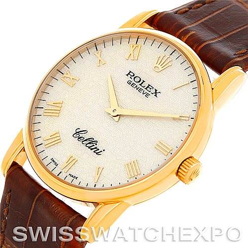 The Rolex Cellini 5116 Men
s Yellow Gold Beige Dial 5116 Men
s Yellow Gold Beige Dial watch is shown from an angled top view, highlighting its dial, case, crown, and leather strap.