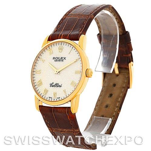 The image shows a Rolex Cellini 5116 Men
s Yellow Gold Beige Dial 5116 Men
s Yellow Gold Beige Dial watch at a three-quarter angle, highlighting its gold case, textured dial, and brown leather strap.