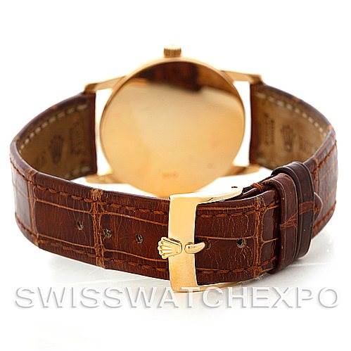 The image shows the back view of a Rolex Cellini 5116 Men
s Yellow Gold Beige Dial 5116 Men
s Yellow Gold Beige Dial watch, highlighting the leather strap and gold clasp.