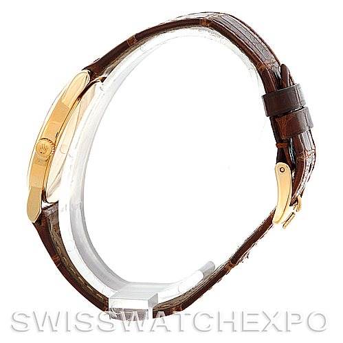 The image shows a side view of the Rolex Cellini 5116 Men
s Yellow Gold Beige Dial 5116 Men
s Yellow Gold Beige Dial model focusing on its brown leather strap and gold buckle.