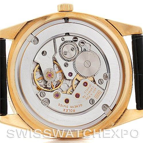 This image shows the back of a Rolex Cellini 4233 Men's Yellow Gold Black Dial 4233 Men's Yellow Gold Black Dial watch, highlighting its internal mechanical movement and gears.
