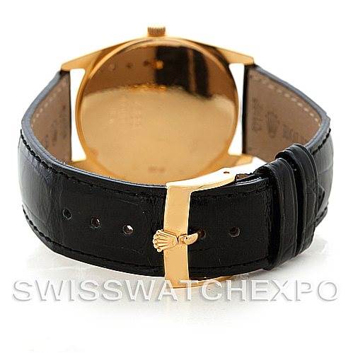 The image shows the back view of a Rolex Cellini 4233 Men's Yellow Gold Black Dial 4233 Men's Yellow Gold Black Dial watch, highlighting the gold case, black leather strap, and buckle.