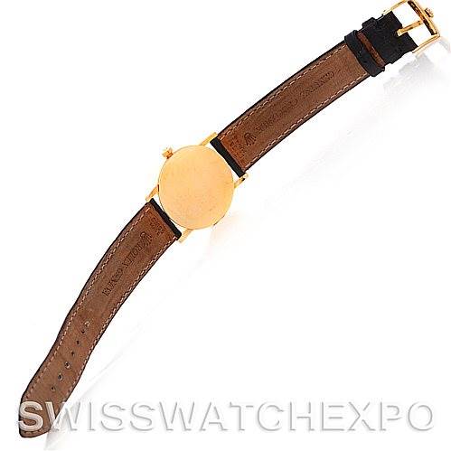 The image shows the underside of a Rolex Cellini 5115 Men's Yellow Gold Black Dial 5115 Men's Yellow Gold Black Dial watch, highlighting its leather strap and gold buckle.