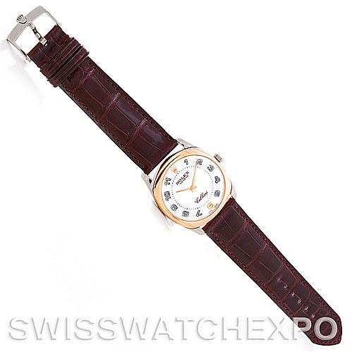 The image shows a top-down view of a Rolex Cellini 4233 Men's White Gold White Dial 4233 Men's White Gold White Dial watch featuring a brown leather strap and a silver and gold case.