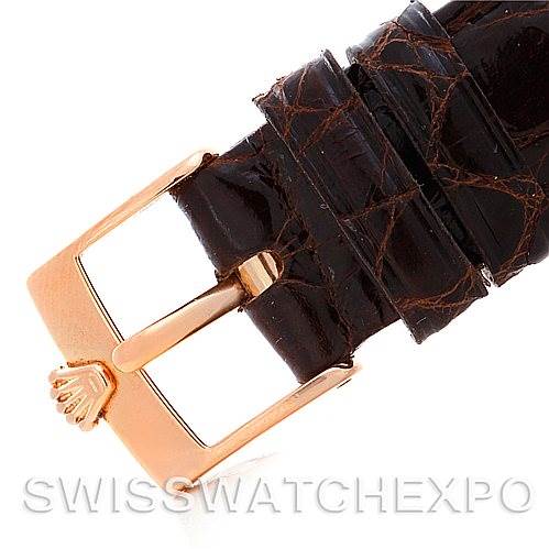 The image shows a close-up of the gold buckle and brown leather strap of a Rolex Cellini 5320/5 Rose Gold White Dial 5320/5 Rose Gold White Dial watch.