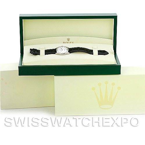 The image shows a Rolex Cellini 4233 Men's White Gold White Dial 4233 Men's White Gold White Dial watch placed inside its open green box, with additional packaging visible in the background.