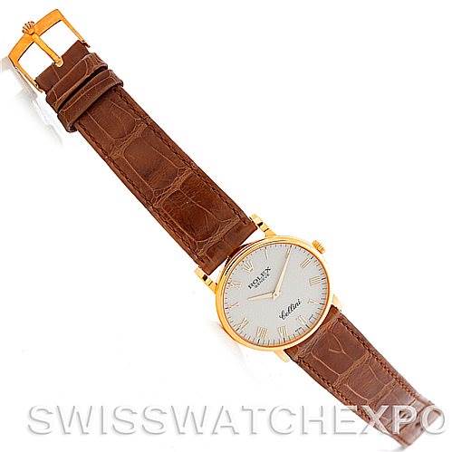 The Rolex Cellini 5115 Men's Yellow Gold Beige Dial 5115 Men's Yellow Gold Beige Dial watch is shown from a top-down perspective, highlighting its brown leather strap and gold case.