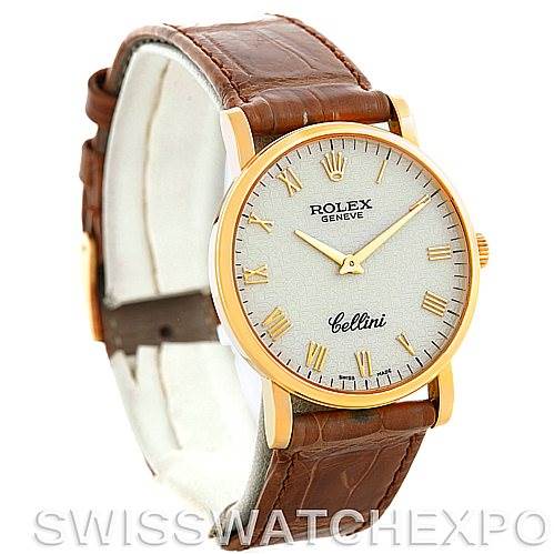 The image shows a side angle of a Rolex Cellini 5115 Men's Yellow Gold Beige Dial 5115 Men's Yellow Gold Beige Dial watch, featuring its face, bezel, and brown leather strap.