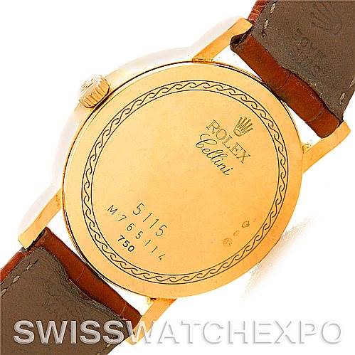 The image shows the back casing of a Rolex Cellini 5115 Men's Yellow Gold Beige Dial 5115 Men's Yellow Gold Beige Dial watch, featuring engraved details and a leather strap.