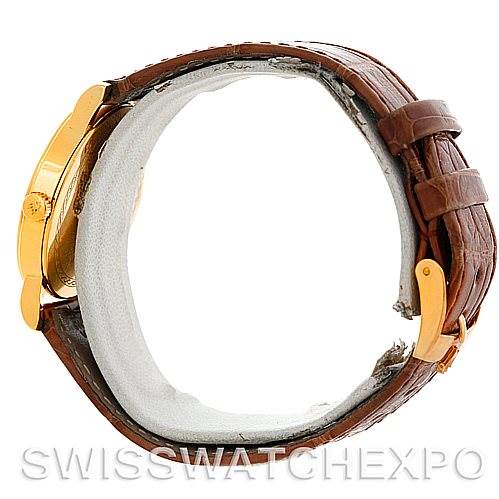 This image shows the Rolex Cellini 5115 Men's Yellow Gold Beige Dial 5115 Men's Yellow Gold Beige Dial model watch from the side, highlighting the gold case, crown, and brown leather strap.