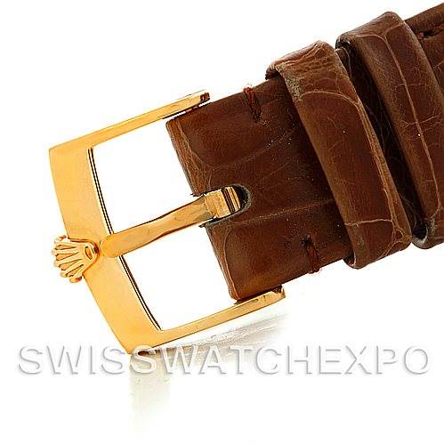 The image shows a close-up of the buckle and strap of a Rolex Cellini 5115 Men's Yellow Gold Beige Dial 5115 Men's Yellow Gold Beige Dial watch, featuring a brown leather strap and gold-tone buckle.