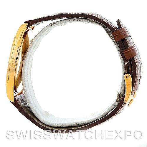 This image shows a side view of a Rolex Cellini 4233 Men's Yellow Gold White Dial 4233 Men's Yellow Gold White Dial watch, highlighting the gold case and brown leather strap with buckle.