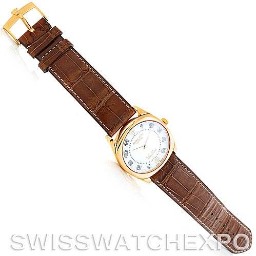 The image shows a top view of a Rolex Cellini 4233 Men's Yellow Gold White Dial 4233 Men's Yellow Gold White Dial watch with a brown leather strap and gold buckle.