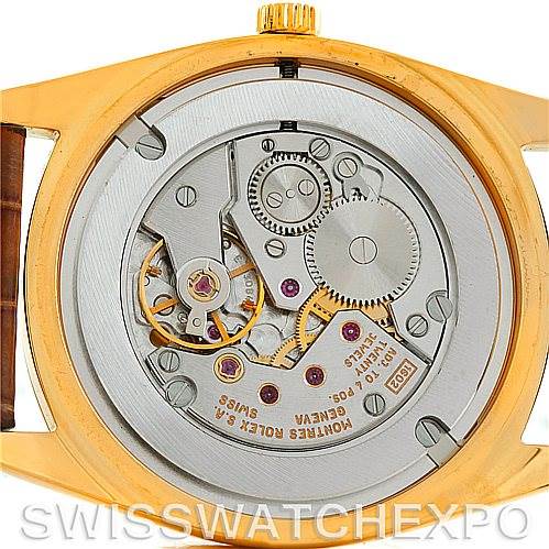 The image shows the back view of a Rolex Cellini 4233 Men's Yellow Gold White Dial 4233 Men's Yellow Gold White Dial watch, highlighting its internal mechanical movement.