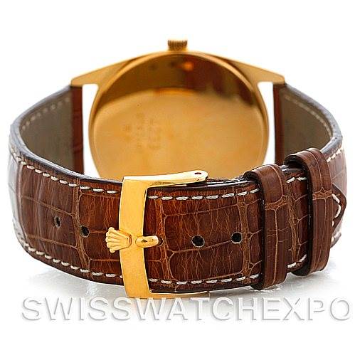 The image shows the back view of a Rolex Cellini 4233 Men's Yellow Gold White Dial 4233 Men's Yellow Gold White Dial watch, highlighting its brown leather strap and gold buckle with the Rolex logo.