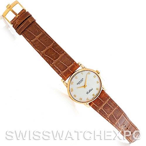 The Rolex Cellini 5116 Men's Yellow Gold Mother of Pearl Dial 5116 Men's Yellow Gold Mother of Pearl Dial watch is shown from a top-down angle, displaying its brown leather strap, gold case, and white dial.